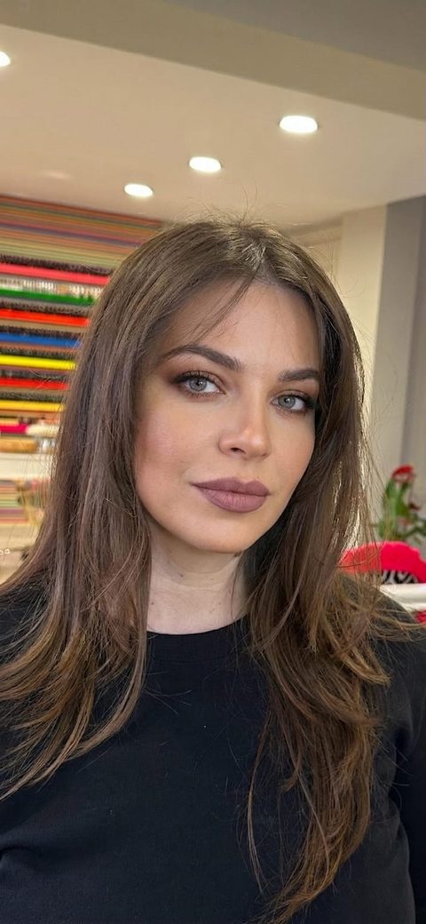 A makeup simulator result: a glam look with smoky eyes and matte lips generated on a woman's own selfie